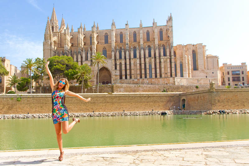 Girl leaping in front of a famous building in Cambridge