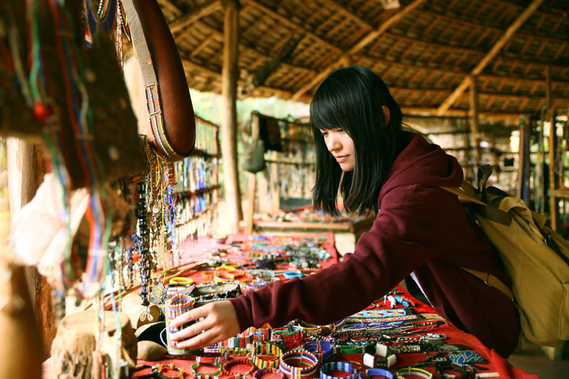 Lady shopping for local handicrafts in a market in Kenya