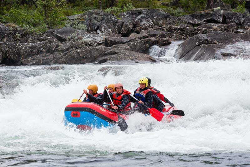 Group of solo travellers white water rafting in Slovenia