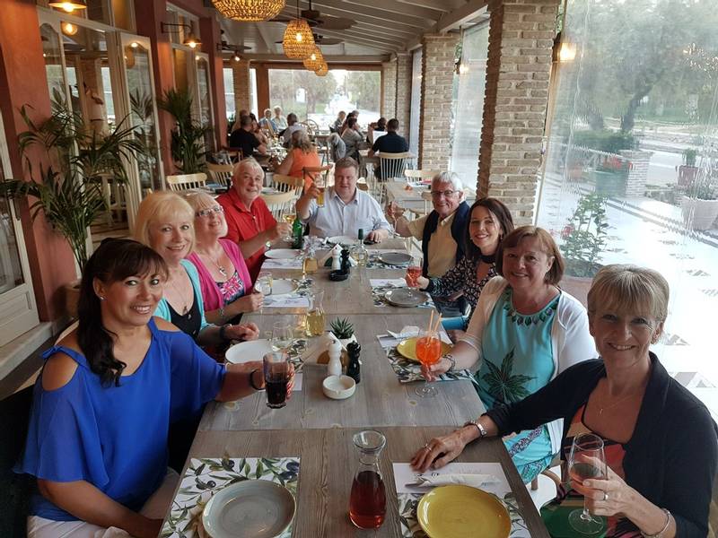 Group of solo travellers enjoying a meal