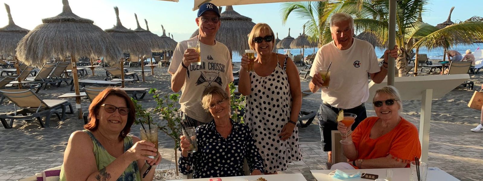 People smiling drinking on beach